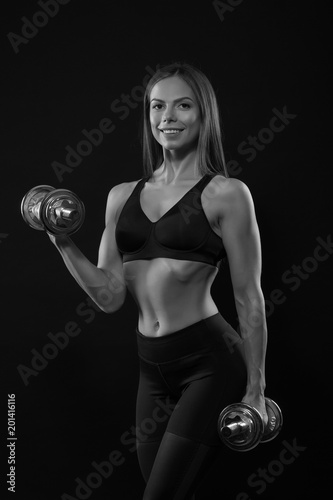 fitness woman in doing exercises with dumbells.