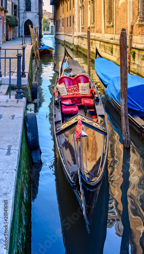 Gondolas parked waiting fro tourists to come back in venice , italy photo
