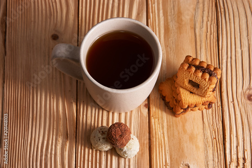 Cup of Tea with Cookies on wooden background photo