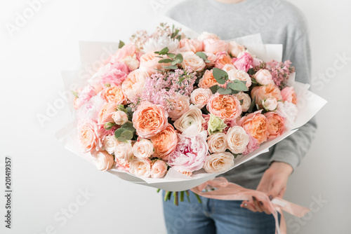 bouquet of beautiful flowers in women's hands. Floristry concept. Spring colors. the work of the florist at a flower shop.