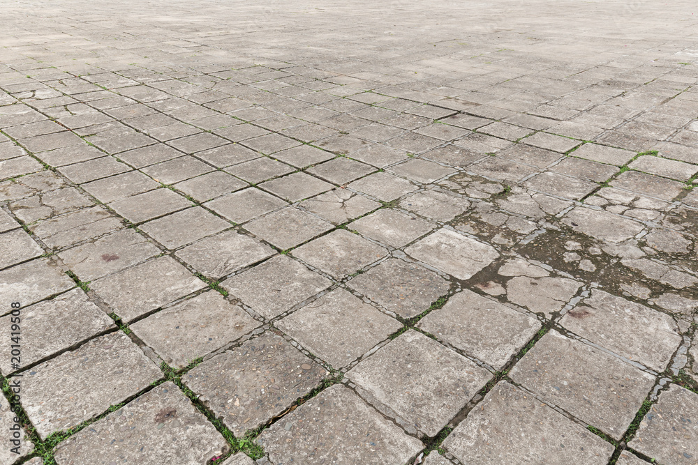 Fototapeta premium Full frame background of old and weathered cement paving slabs outdoors