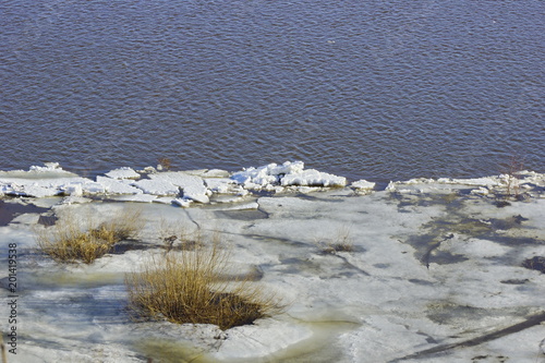 ice drift on the river. large ice floes floating on the water. spring is melting ice cracking. top view of the river
