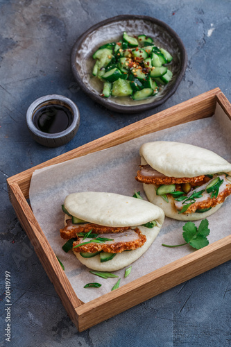 Gua bao, chinese steamed buns, with pork belly in a wooden box photo