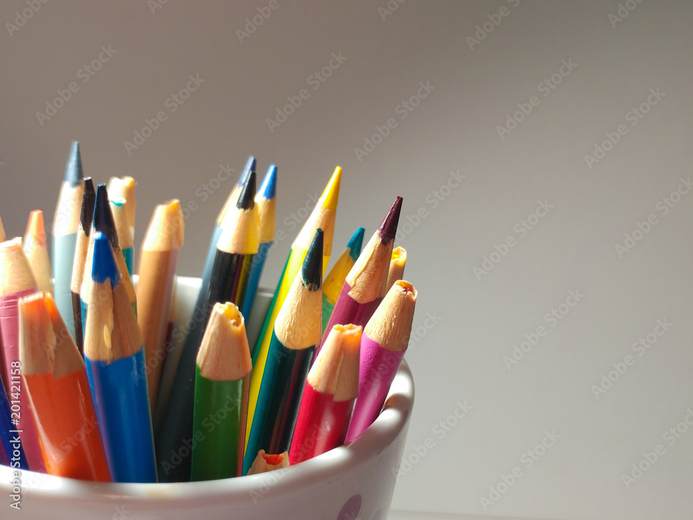 Sharpened Colored Pencils sticking out of a cup. Sharpened Colored Pencils sticking out of a cup.