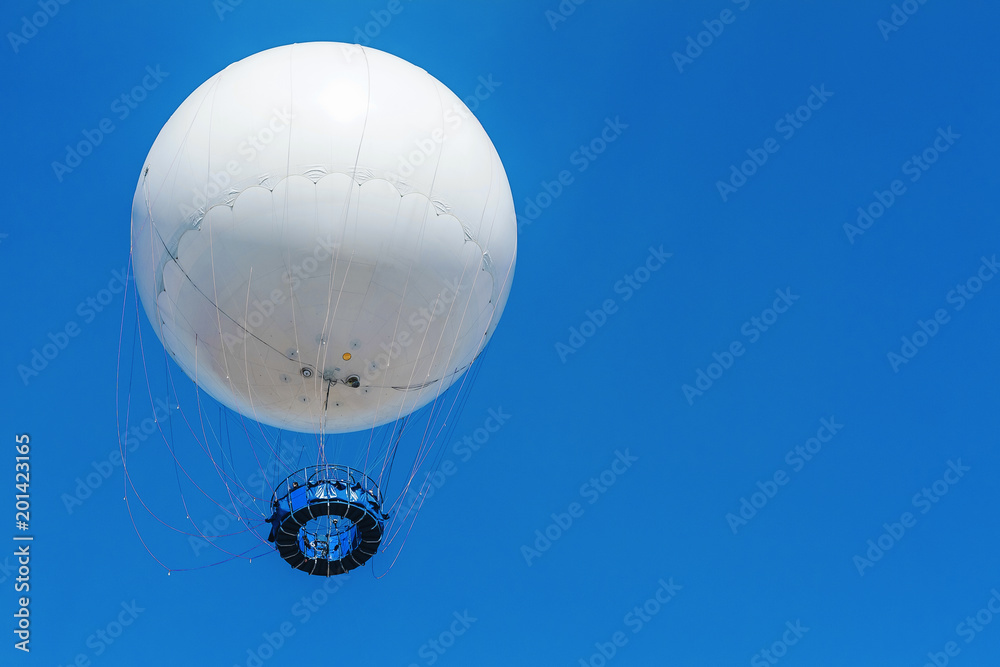 white balloon flies on a background of blue sky white balloon flies on a background of blue sky