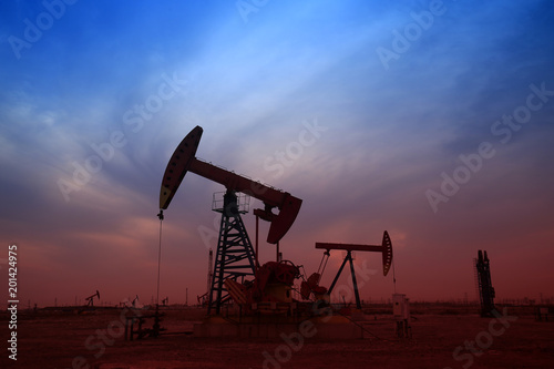 Pumping unit in the work, under the background of the setting sun