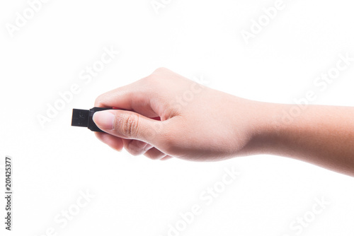 Woman hand holding up a flash drive isolated on a white background