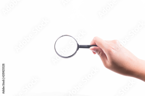 Female hand with magnifying glass.
