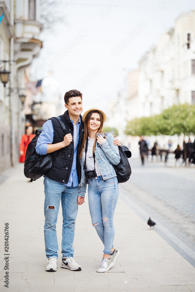 Young freelancing photographers enjoying traveling and backpacking. Young couple with backpack travel new destination