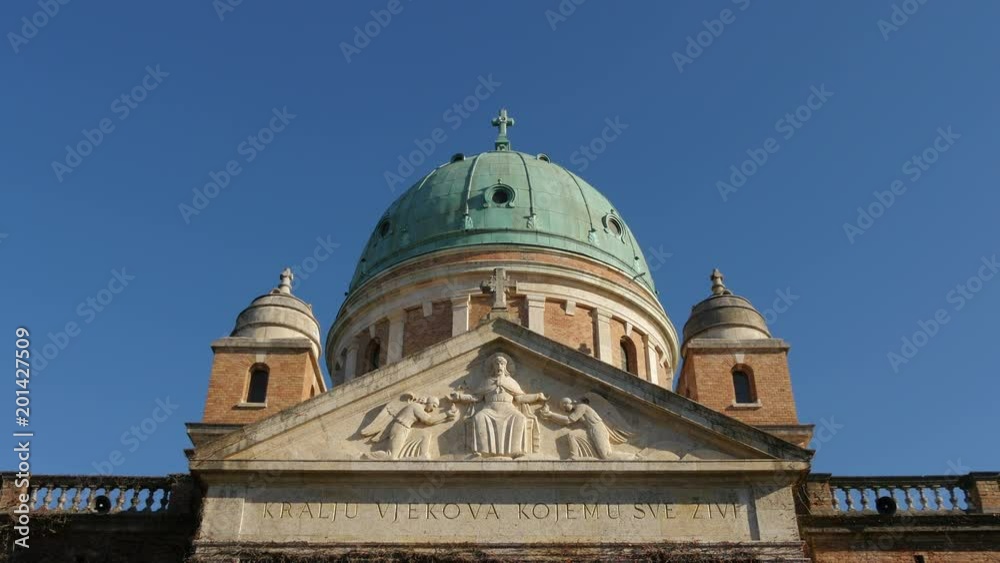 A sculpted pediment by a church dome