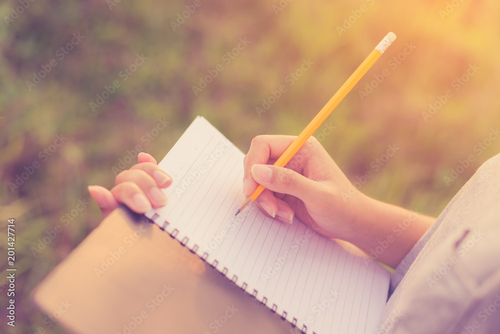 Woman writing in the notebook Woman writing in the notebook