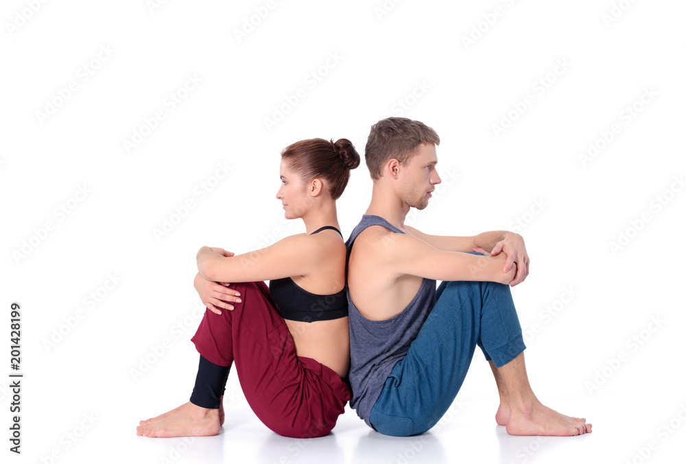 Young athletic couple practicing acroyoga. Balancing in pair. Young athletic couple practicing acroyoga. Balancing in pair.
