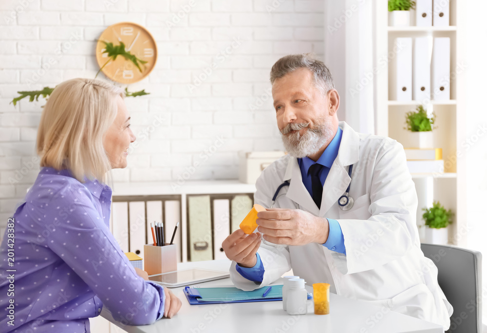 Mature doctor consulting patient in clinic Mature doctor consulting patient in clinic