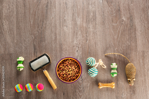 Flat lay composition with cat accessories and food on wooden background