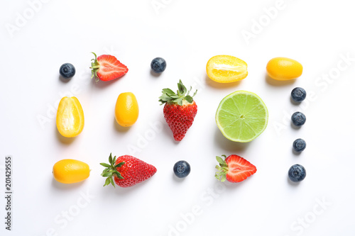 Fototapeta Naklejka Na Ścianę i Meble -  Fresh fruits and berries on white background, top view