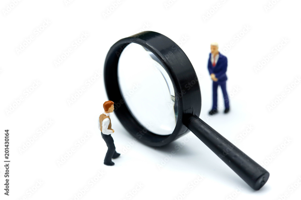 Miniature people : young businessman with magnifying glass of Successful businessman,Business Growth concept. Miniature people : young businessman with magnifying glass of Successful businessman,Business Growth concept.