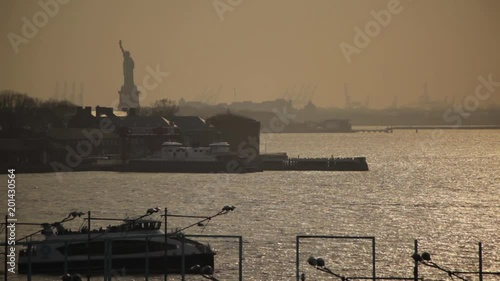 Ferry With The Statue Of Liberty At Sunset