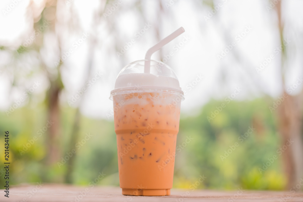 Ice thai tea on wooden table Ice thai tea on wooden table