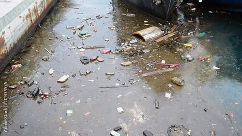 Water pollution old garbage and oil patches on sea surface.