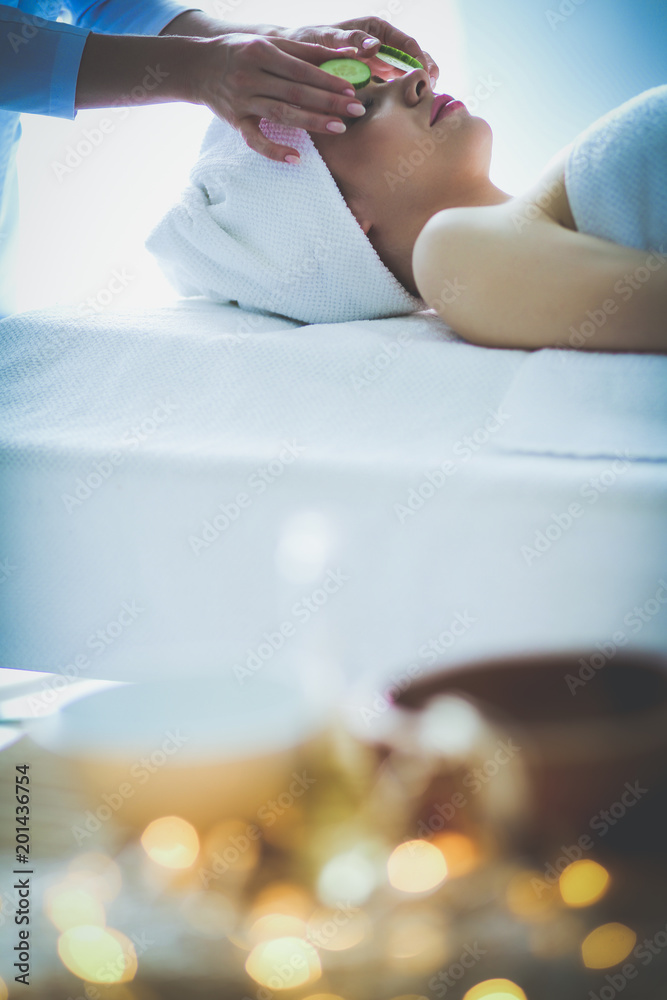 Young woman lying on a massage table,relaxing with eyes closed. Woman. Spa salon Young woman lying on a massage table,relaxing with eyes closed. Woman. Spa salon