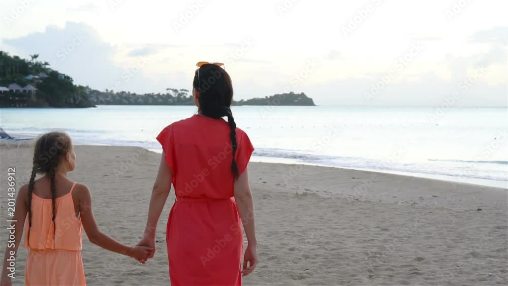 Beautiful mother and daughter on Caribbean beach. Family beach vacation Beautiful mother and daughter on Caribbean beach. Family beach vacation
