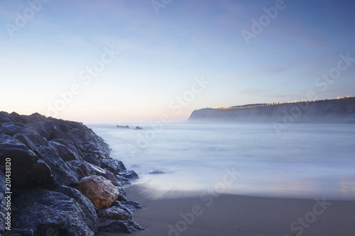 Serene seascape in Arrigunaga beach, Biscay, Basque Country, Spain. Long exposure on a misty sunset. photo