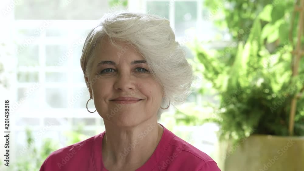 Woman with short hair smiling towards camera and looking away. Woman with short hair smiling towards camera and looking away.