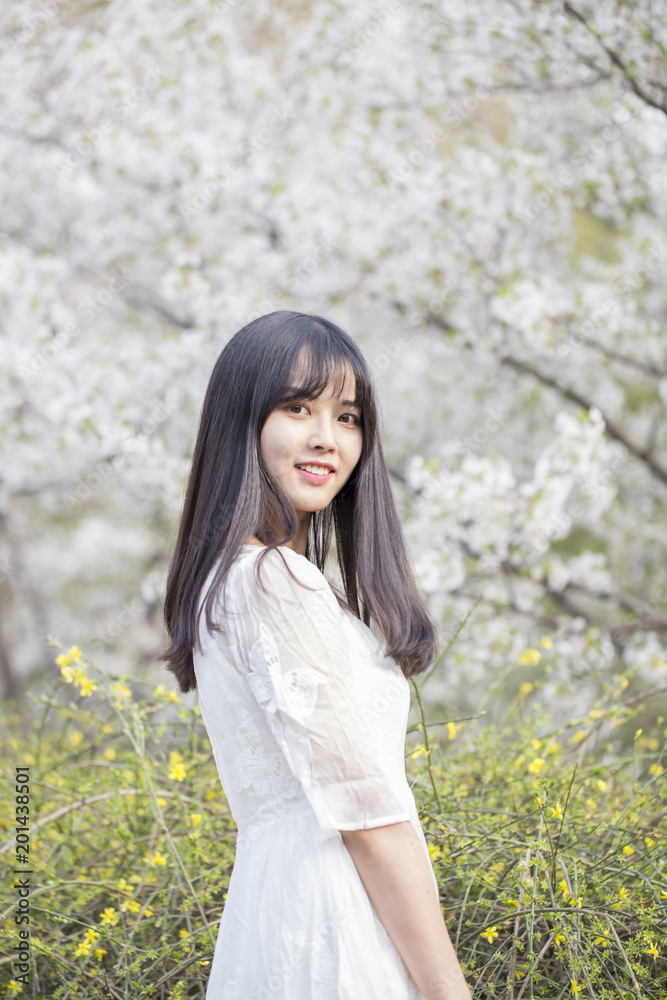 Beautiful girl enjoying the spring flower outdoors in the park Beautiful girl enjoying the spring flower outdoors in the park