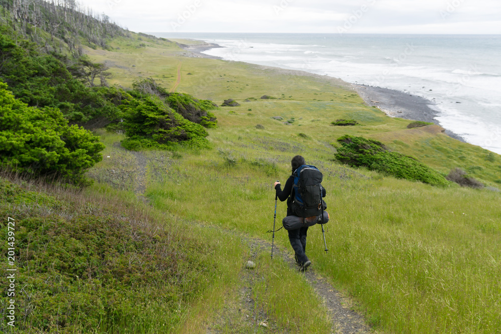 Young woman backpacker  on the Lost Coast backpacking trail in California
