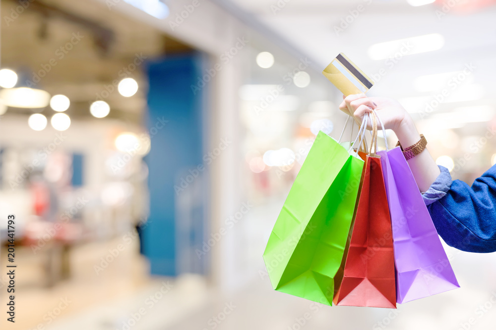 Woman with shopping bags with colourful and creditcard with cloth shop background - Shopping credit card payment concept Woman with shopping bags with colourful and creditcard with cloth shop background - Shopping credit card payment concept