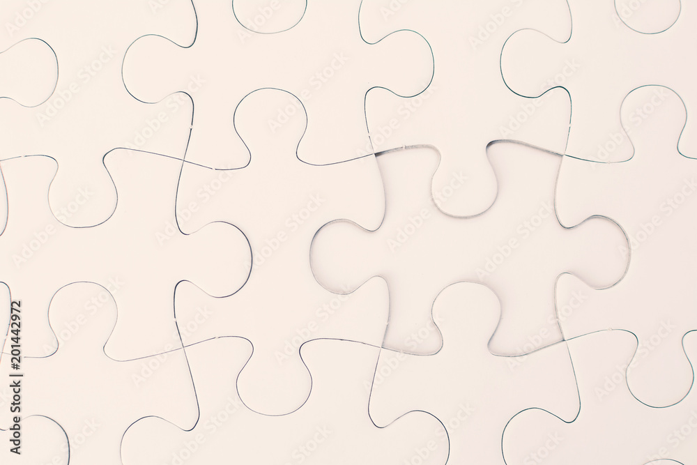 Close up white jigsaw background Close up white jigsaw background