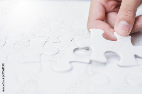 Close up girl's hand playing jigsaw