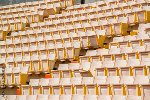 Many chairs in football stadium.
