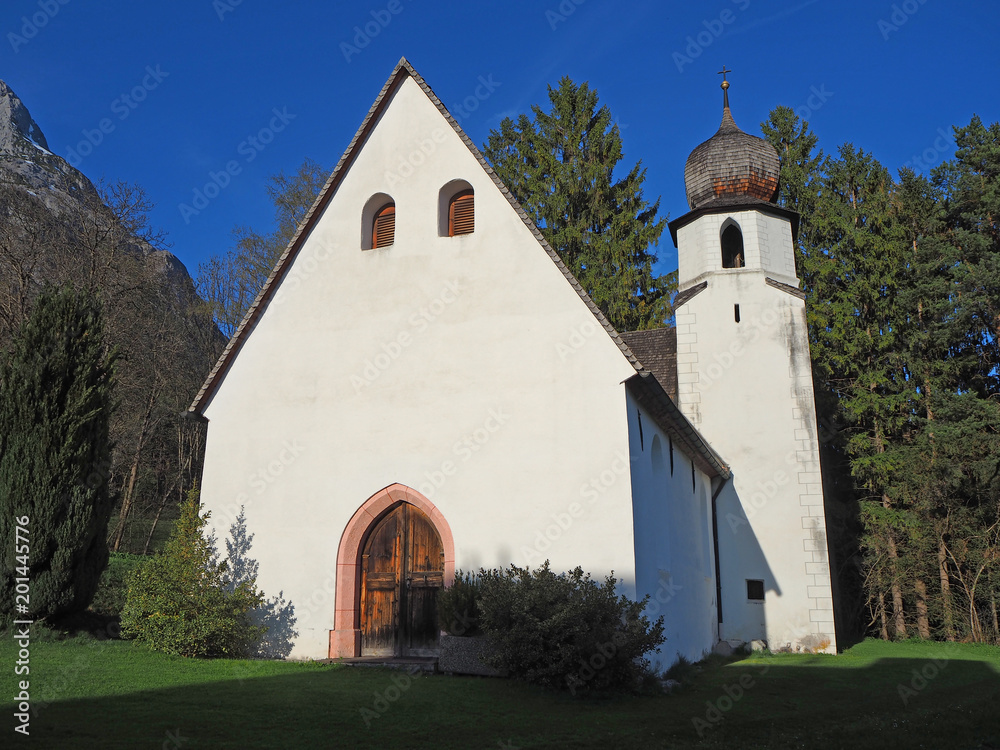 Fototapeta premium Traditional Austrian church in mountain environment