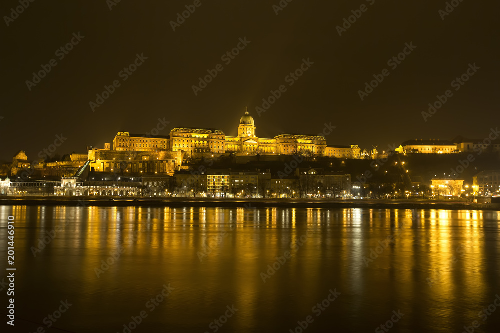 Panoramic view of Budapest by night on Danube river.
