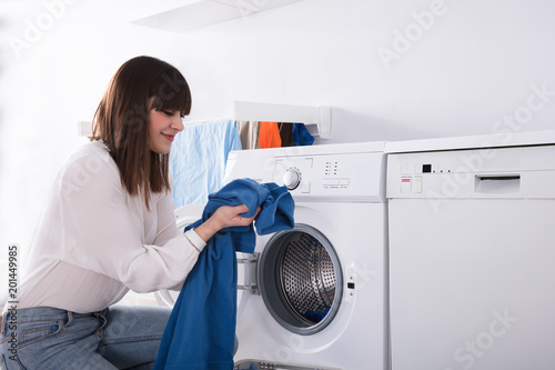 Young Woman Smelling Blue Cloth