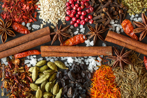 Aromatic Indian spices on a gray slate background.