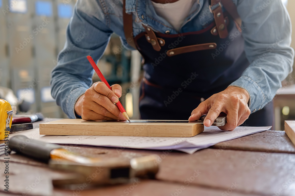 Carpenter working on woodworking machines in carpentry shop. woman works in a carpentry shop.