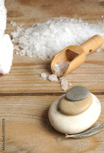 Stones stacked with a slide and a spatula with salt for spa treatments