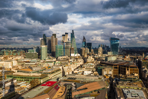 Fototapeta Naklejka Na Ścianę i Meble -  London, England - Panoramic skyline view of Bank and Canary Wharf, central London's leading financial districts with famous skyscrapers and other landmarks at golden hour sunset. Dramatic sky behind