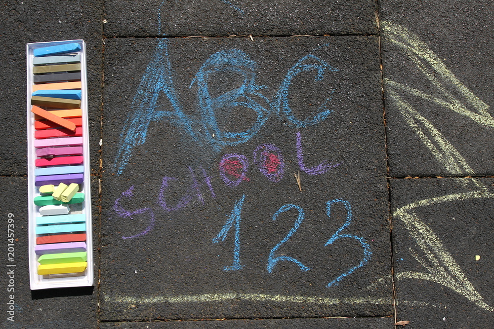 Obraz premium School, ABC and 123 sigh written with colored chalks on a pavement. Drawing Back to school on an asphalt. and vacation concept. Education concept. School and fun time. No sharpen. 