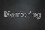 Education concept: text Mentoring on Black chalkboard background