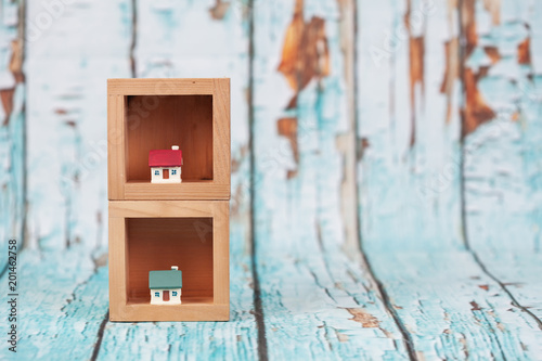 miniature house on wood stand with wood  wall . © amnarj2006