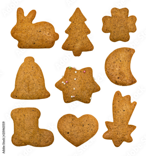 Set of ginger flavored cookies. Isolated on white. In the shape of a rabbit, a Christmas tree, a heart, a spark.