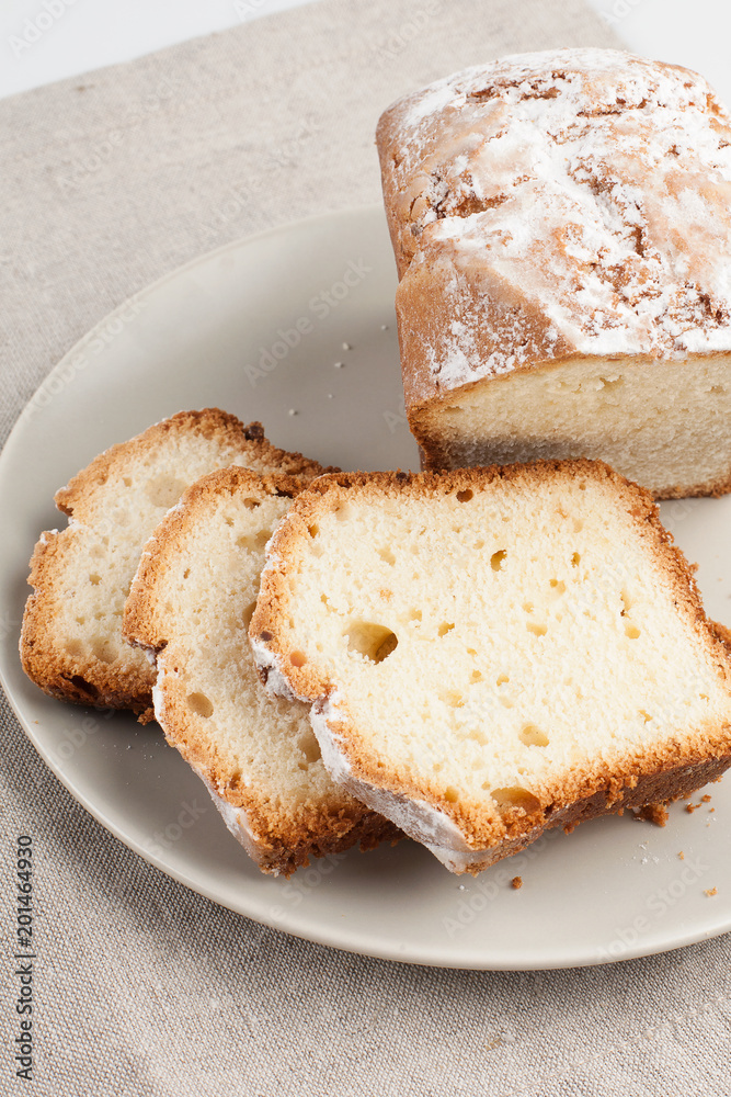 Butter cake sliced into pieces on linen background Butter cake sliced into pieces on linen background