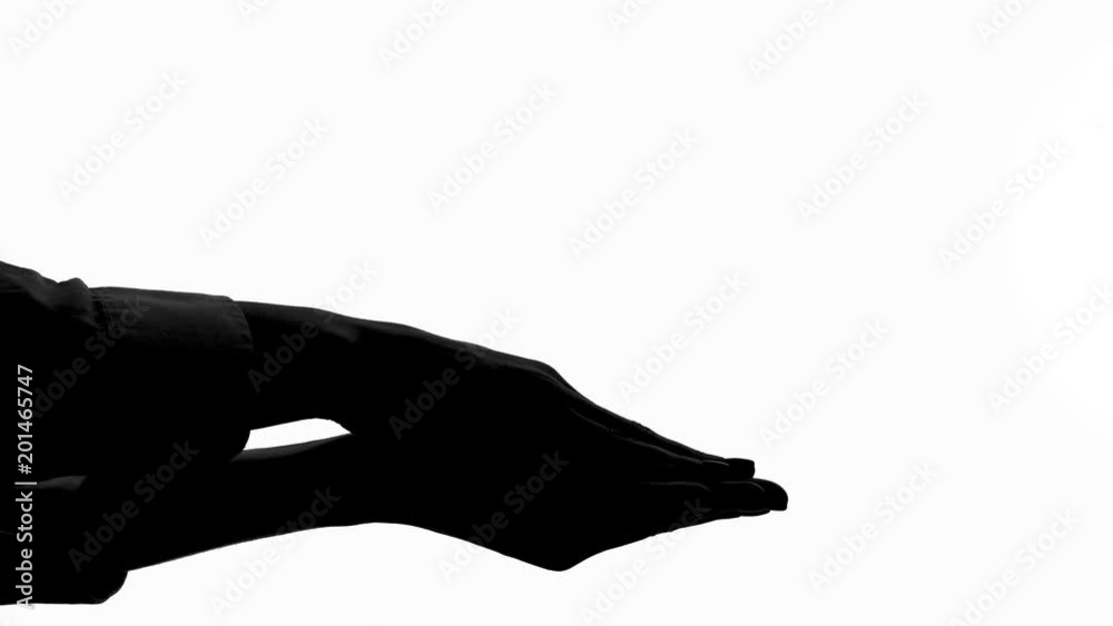 Silhouette of female hand holding and crushing tiny man, womens authority