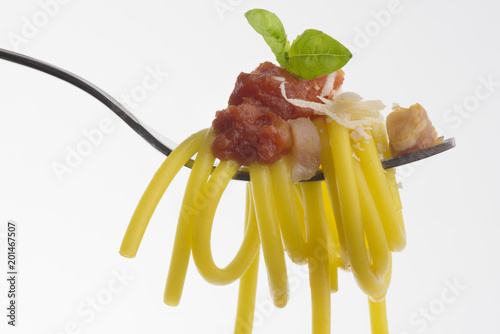 fork with spaghetti and amatriciana sauce isolated on white background
