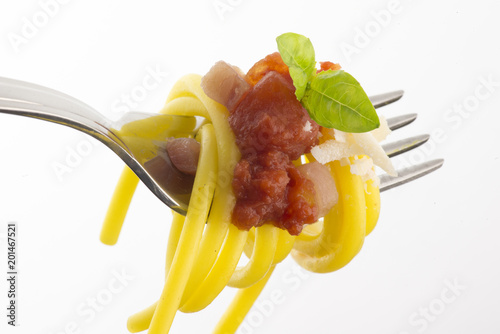 fork with spaghetti and amatriciana sauce isolated on white background