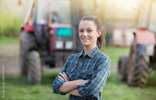 Photographie Farmer woman with tractors on farmland