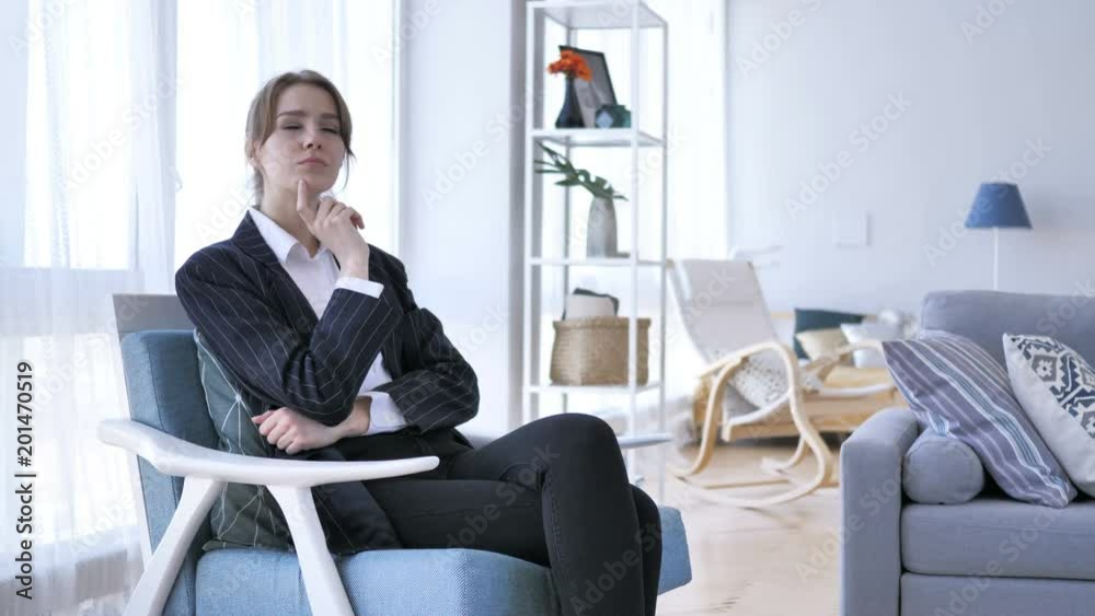 Pensive Woman Thinking while Sitting on Sofa